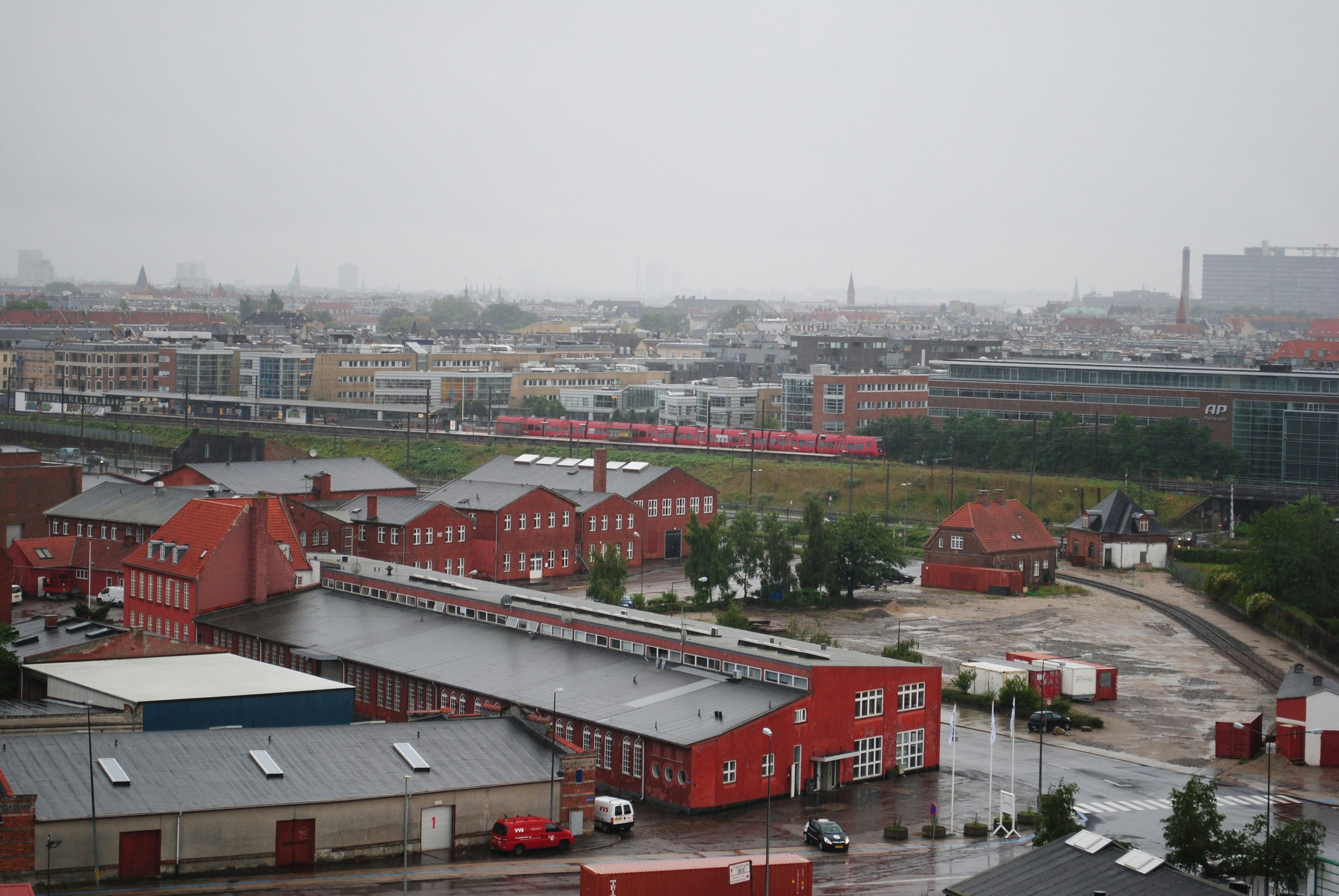 Overcast sky above industrial buildings and city skyline