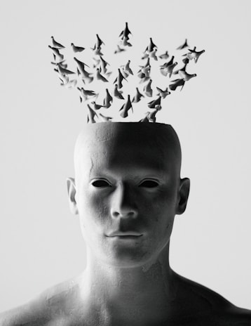 Abstract human head with flock of birds emerging
