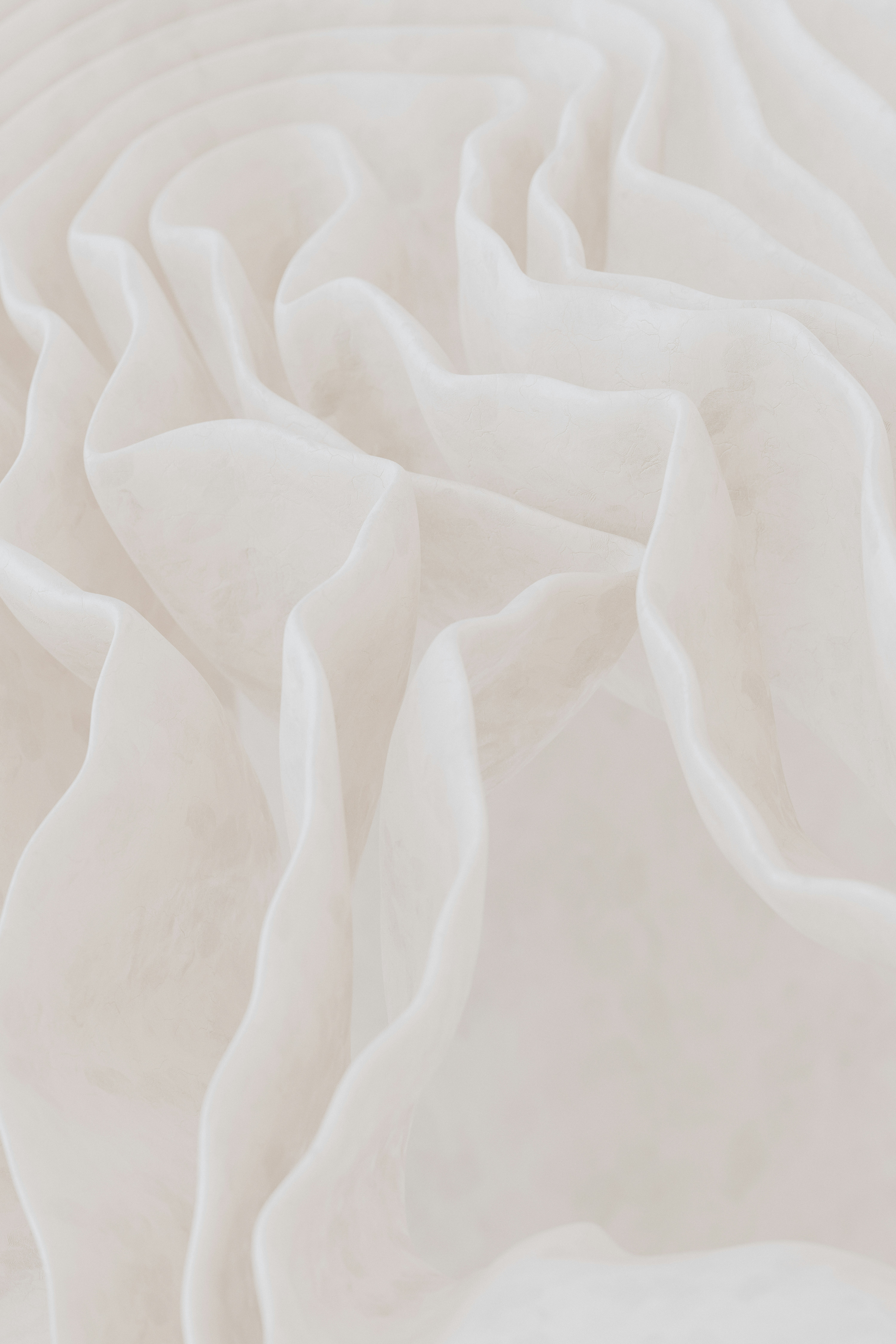 Soft white fabric folds with gentle texture.