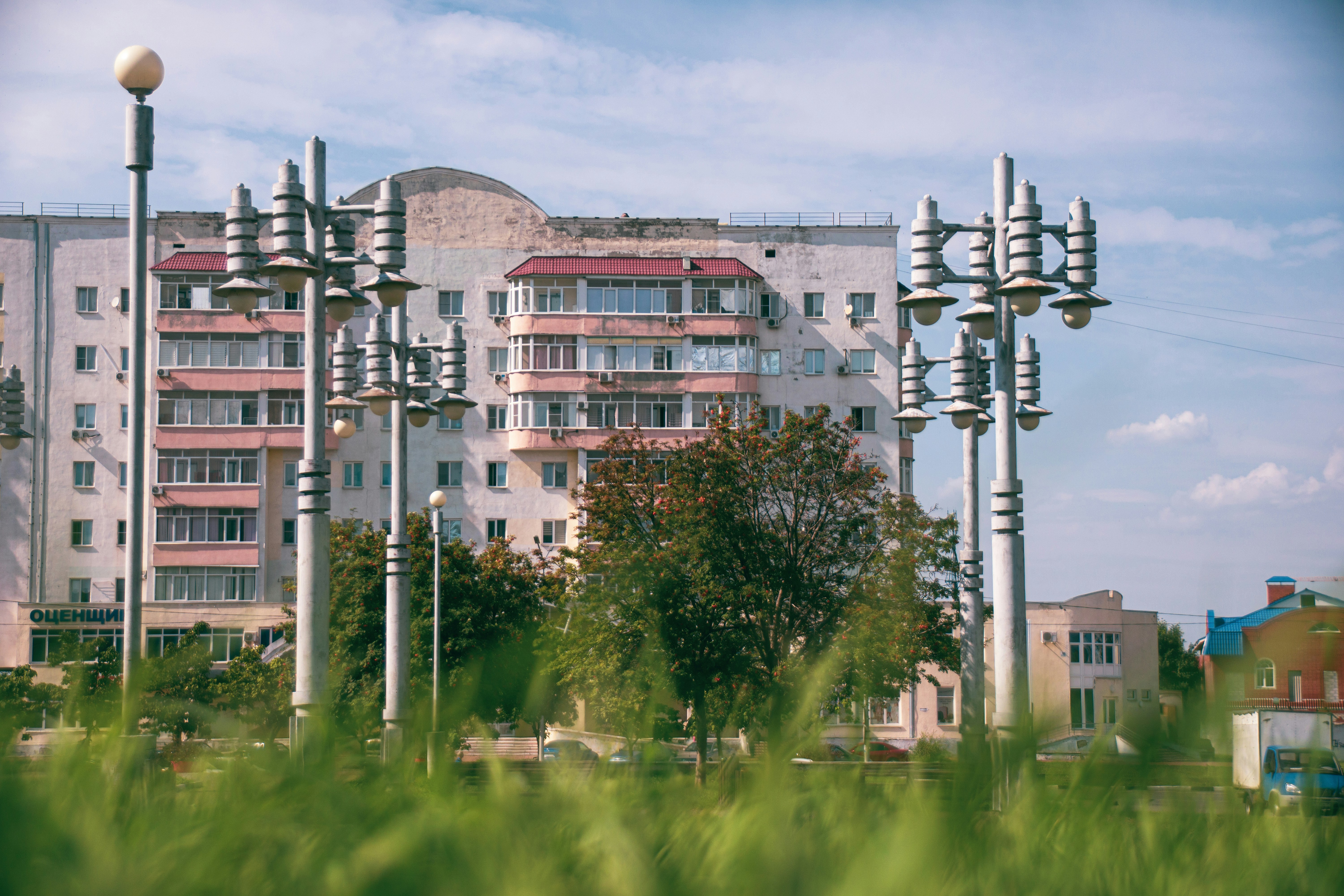 Apartment building with streetlights and trees