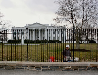 White house with a worker near the fence