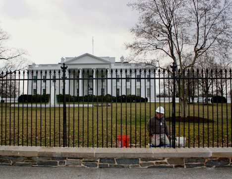 White house with a worker near the fence