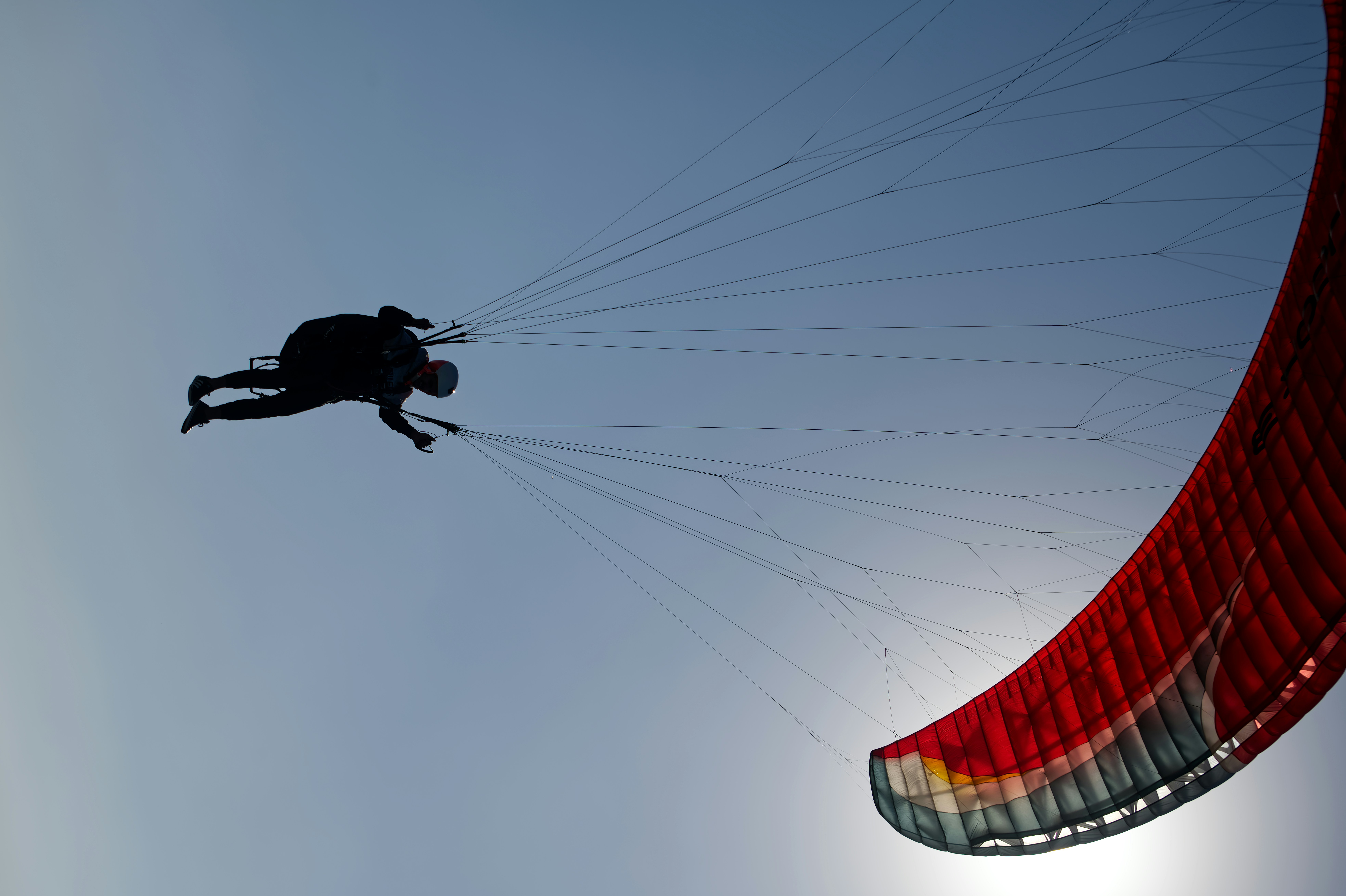 skydiver floating under parachute with red 'no insurance' stamp overlay
