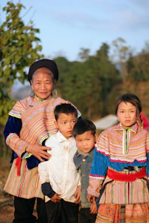 Family in traditional ethnic clothing posing outdoors