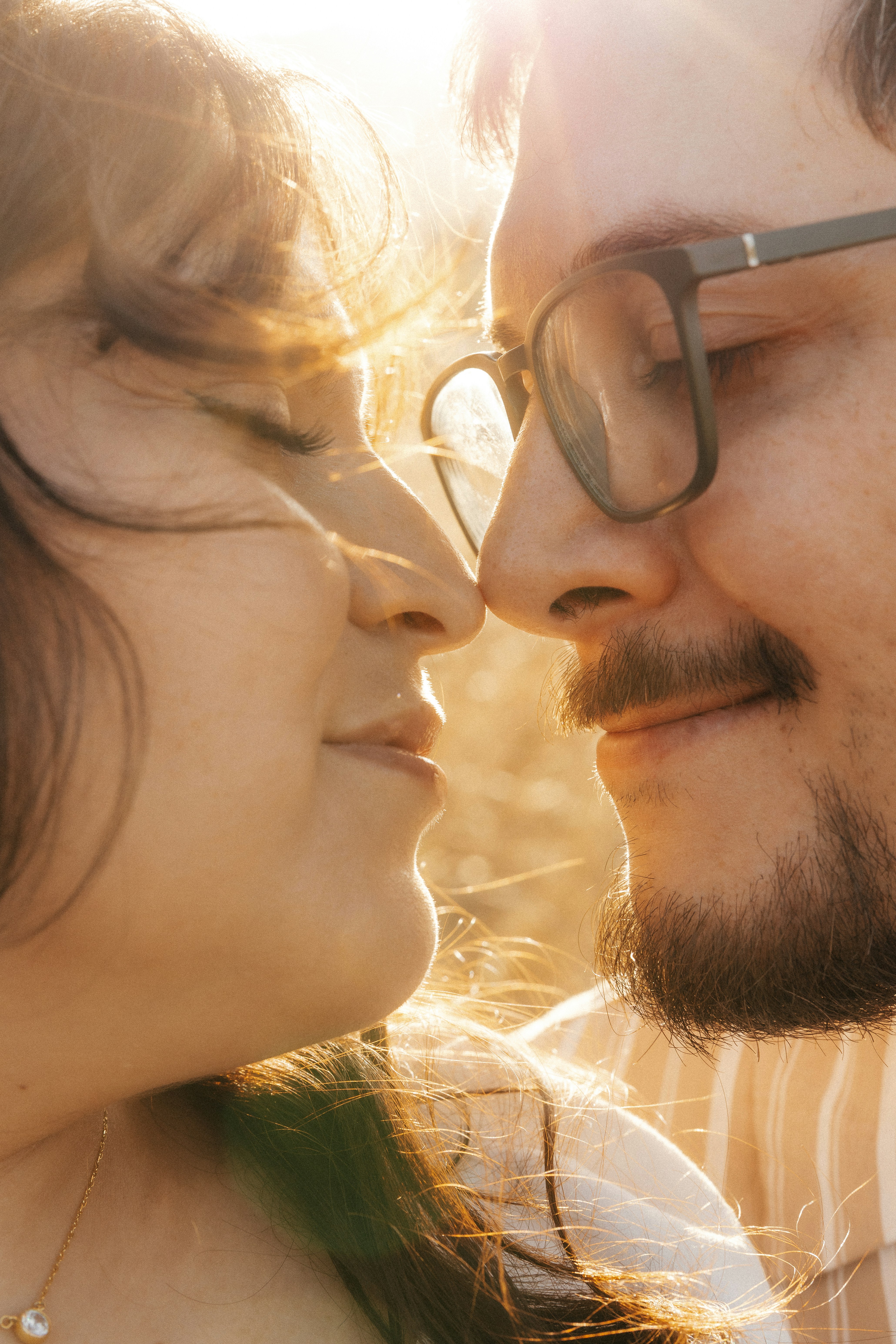 Couple sharing a tender moment in golden hour light