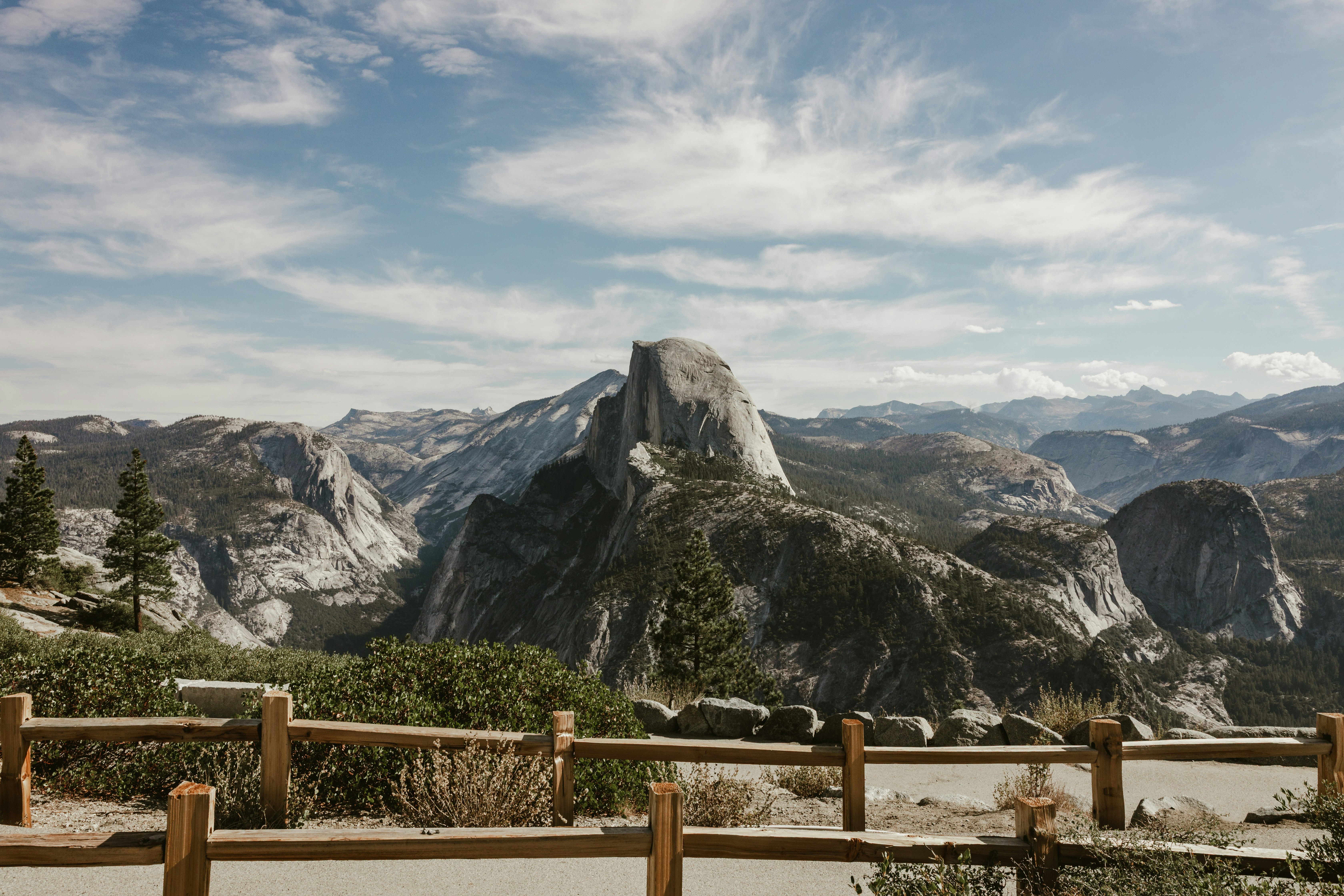 Majestic half dome mountain range under a cloudy sky.