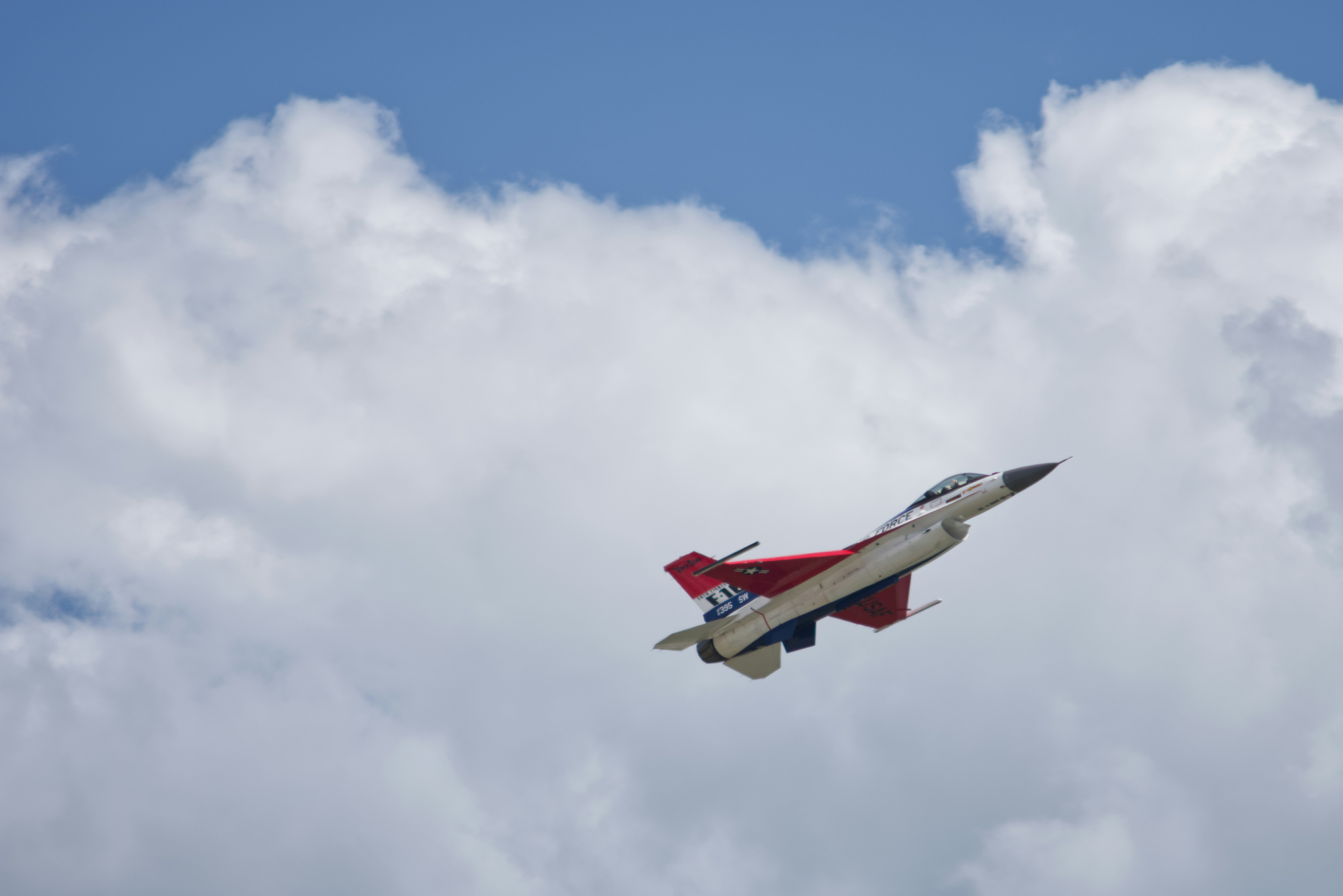 Fighter jet flies through a cloudy sky