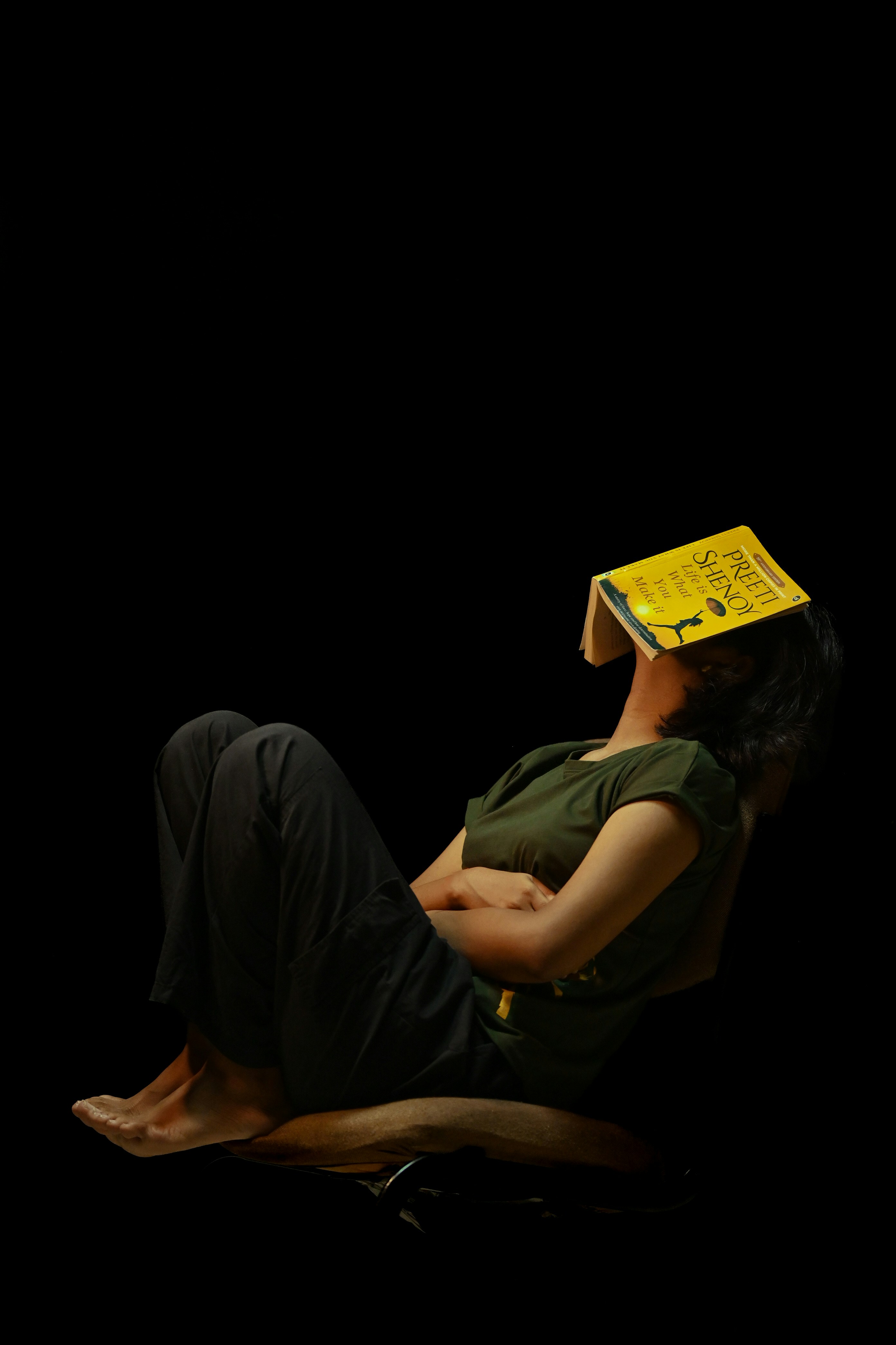 Person resting with a book on their face.