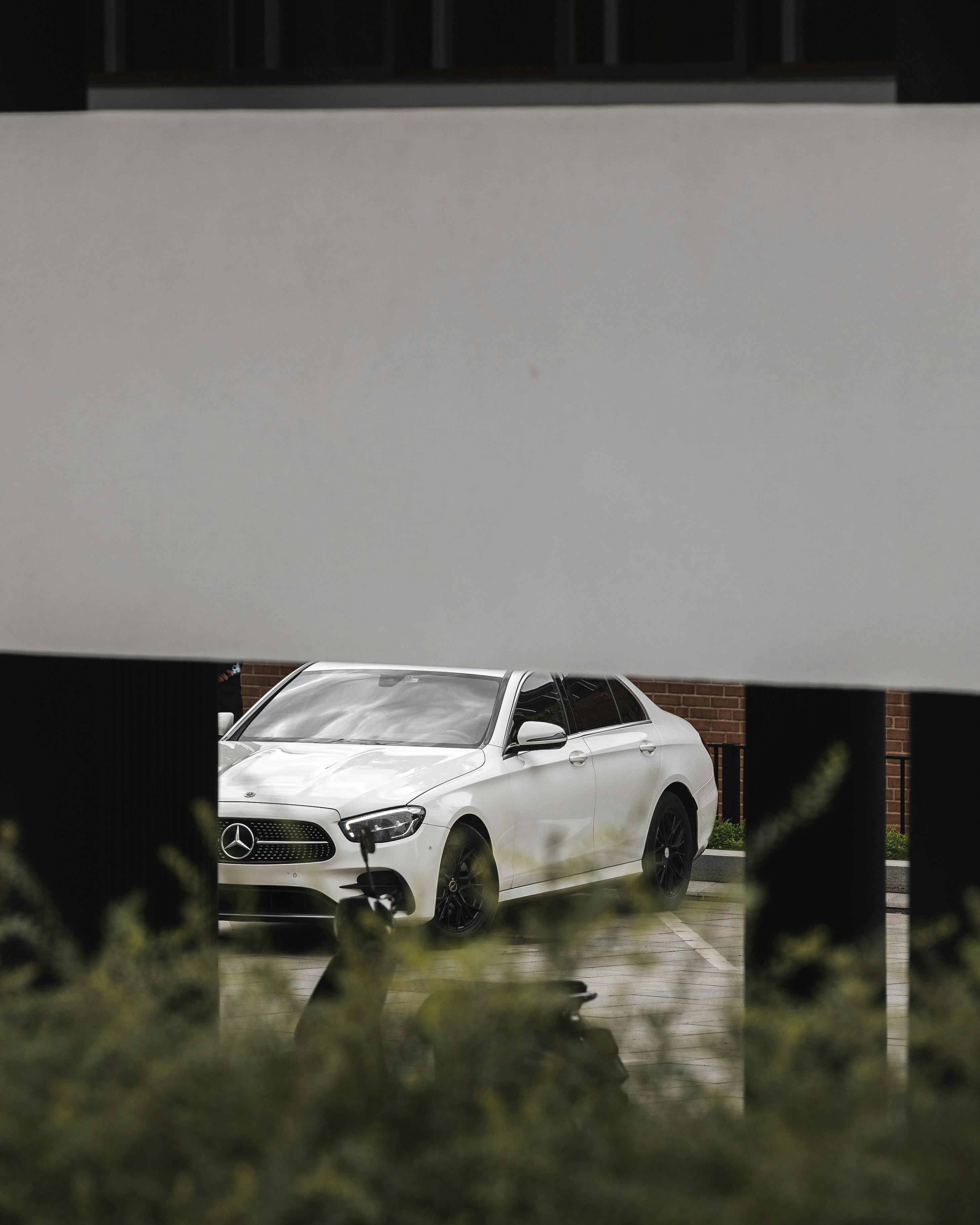White mercedes sedan parked outside building
