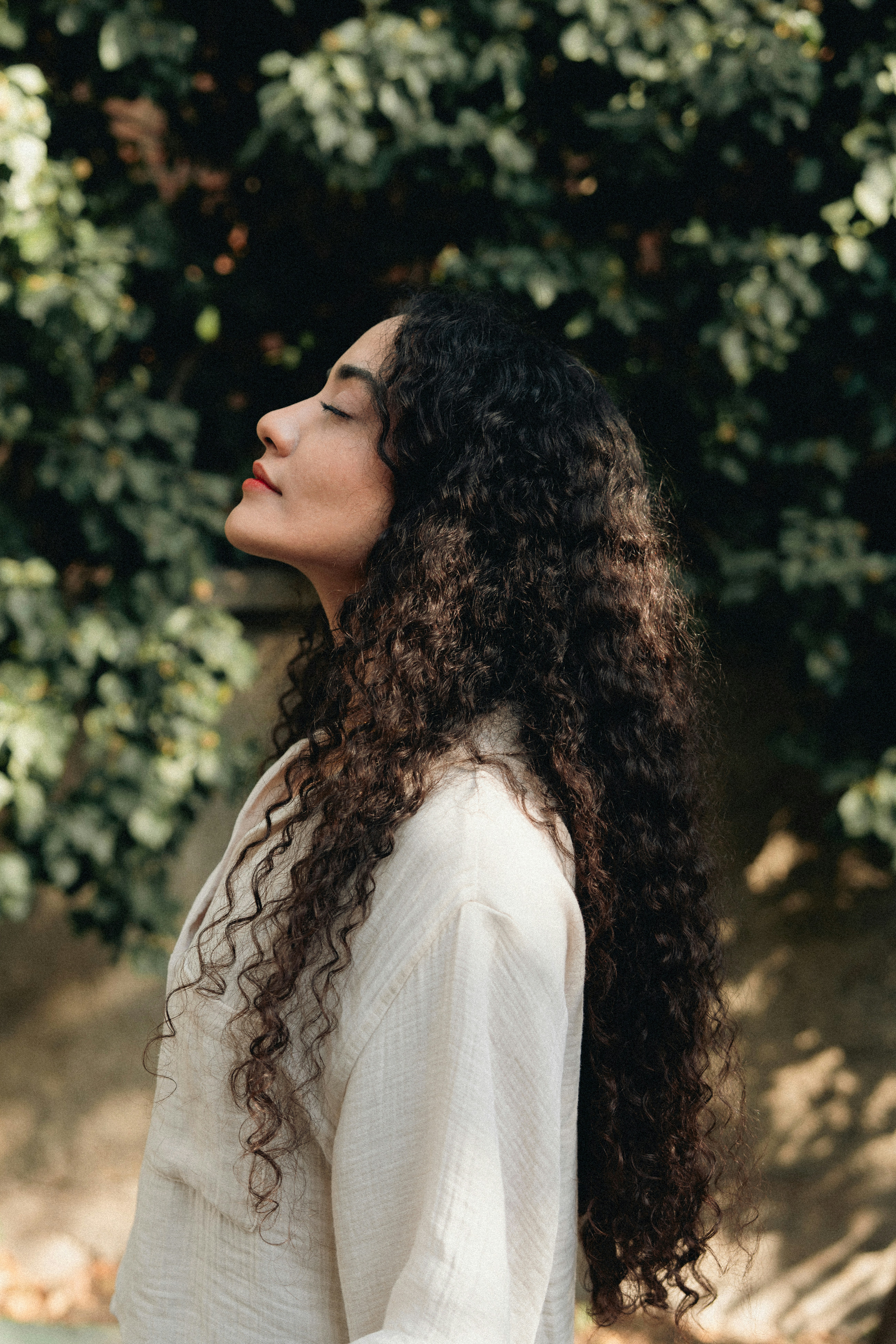 Woman with long curly hair enjoying the sun
