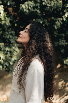 Woman with long curly hair enjoying the sun