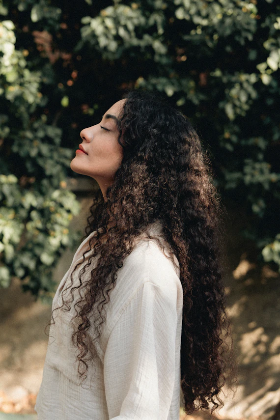 Woman with long curly hair enjoying the sun