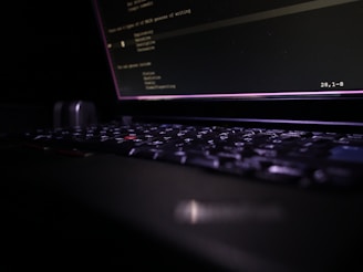 Close-up of a laptop keyboard in the dark