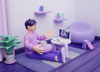 Man on floor video calling on laptop with coffee