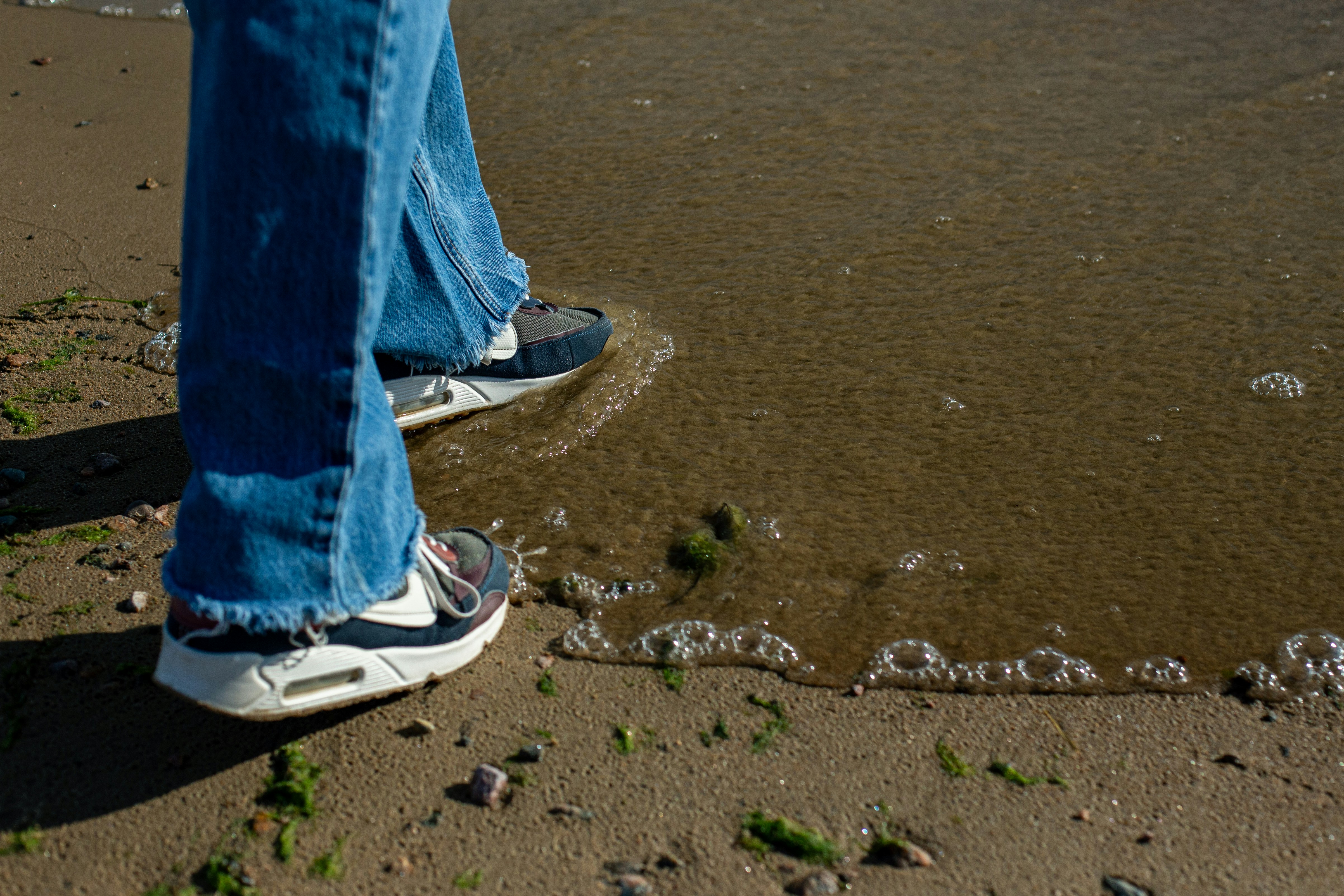 Person walking at the edge of the water