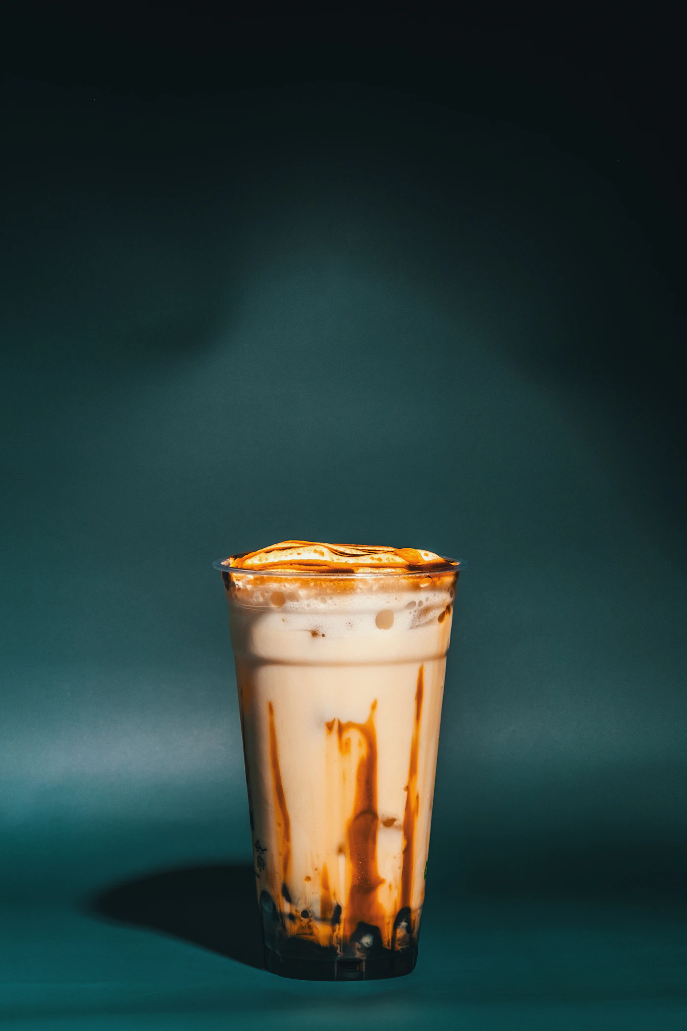Logo-free brown sugar milk tea with caramel swirls and tapioca pearls