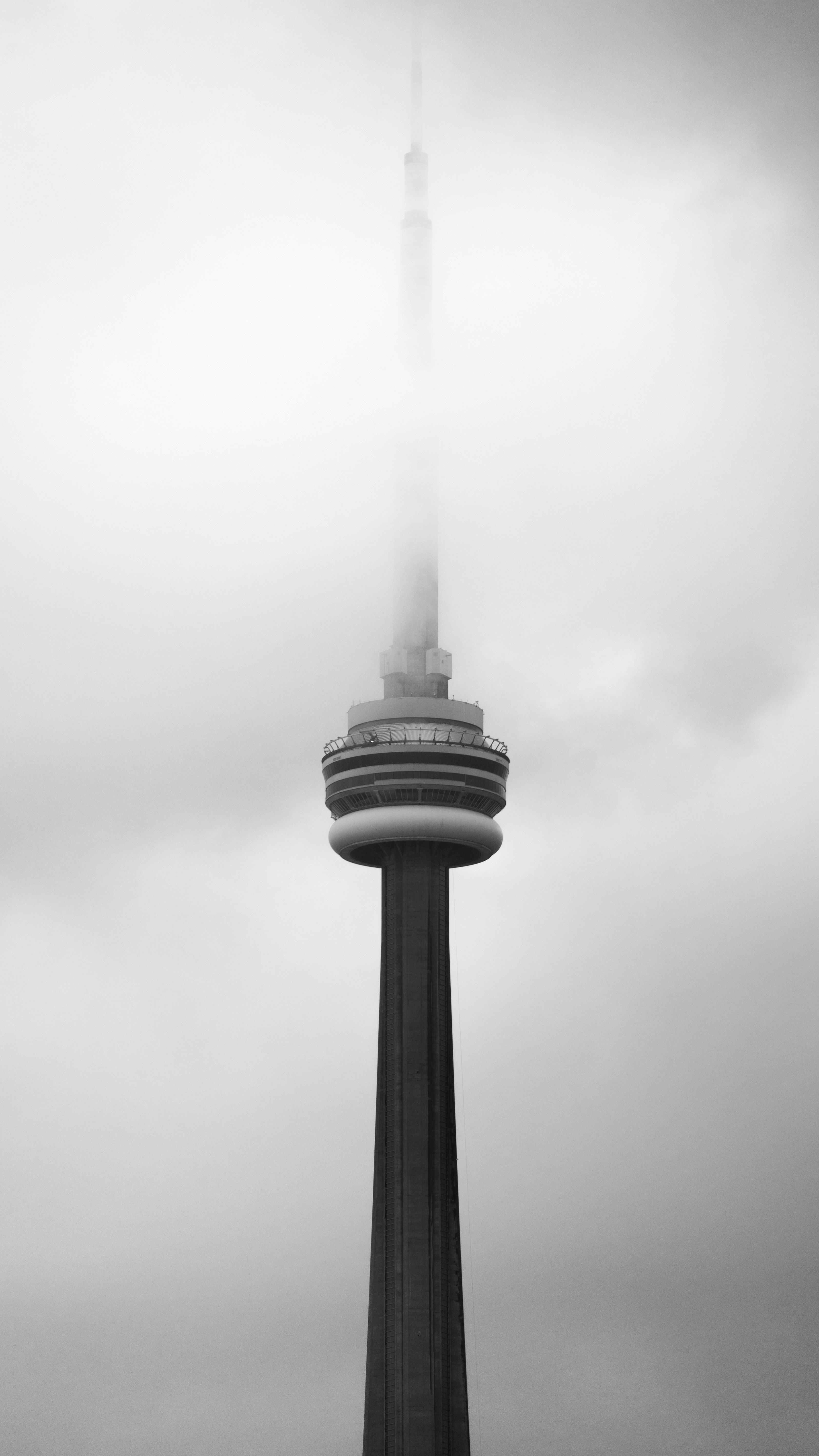 Tall tower emerging from thick fog