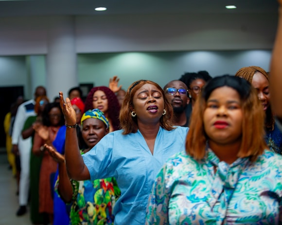 A group of people with hands raised in worship