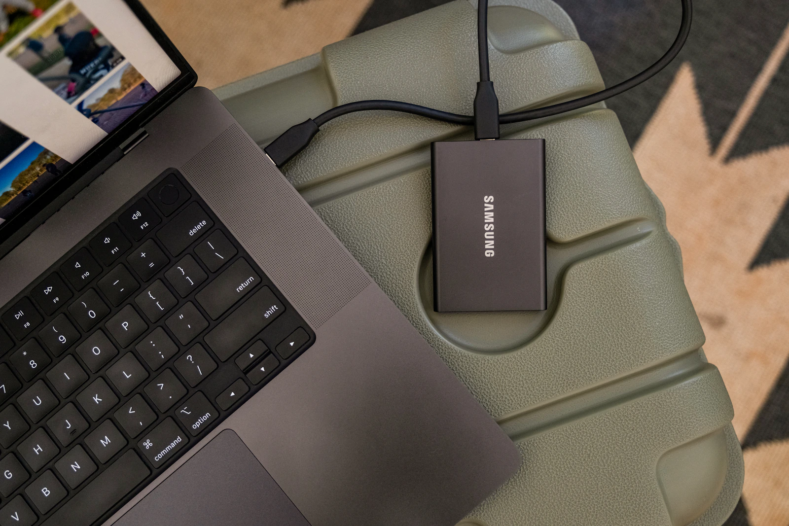An external storage drive connected to a laptop for backing up files.