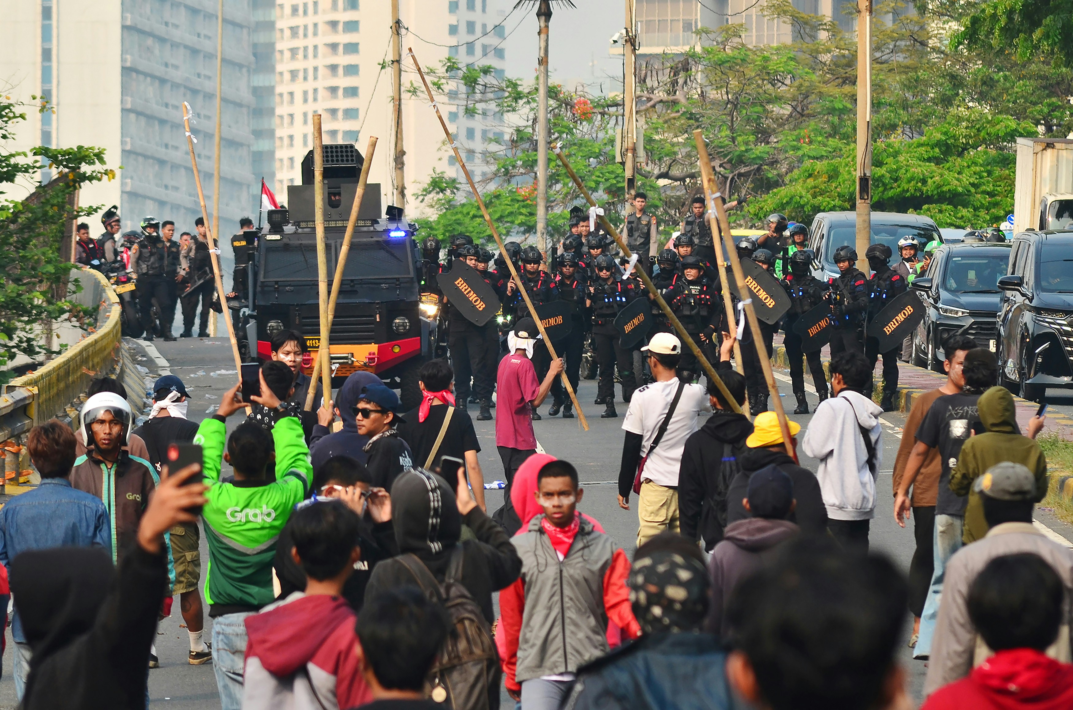 Protesters confront police line with shields and shields.