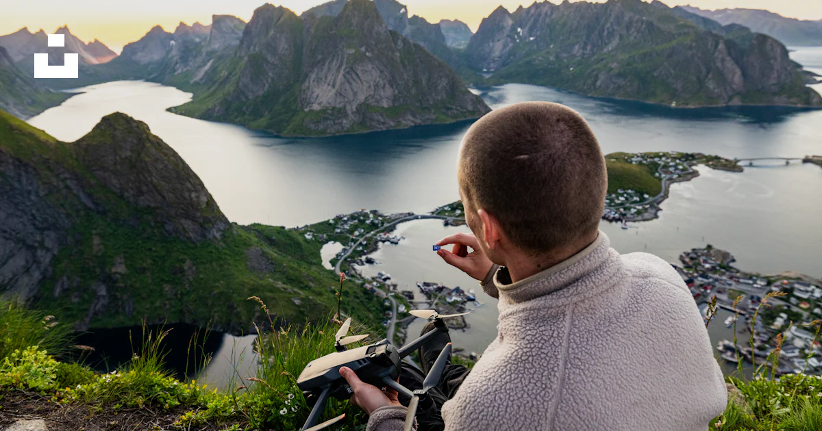 Man Painting A Scenic Norwegian Fjord Landscape From Above Photo Free man-painting-a-scenic-norwegian-fjord-landscape-from-above-photo-free
