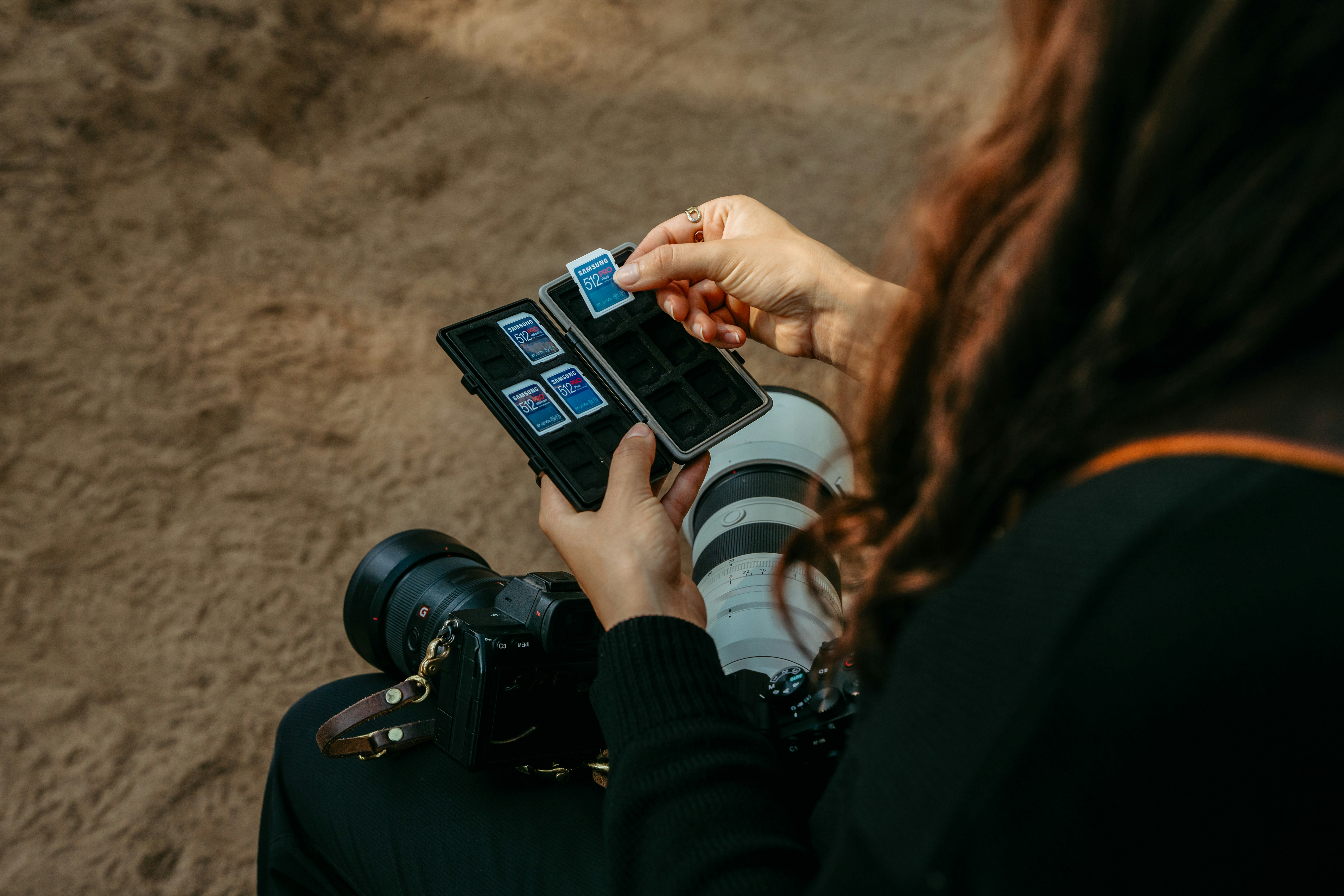 Woman holding memory cards and phone