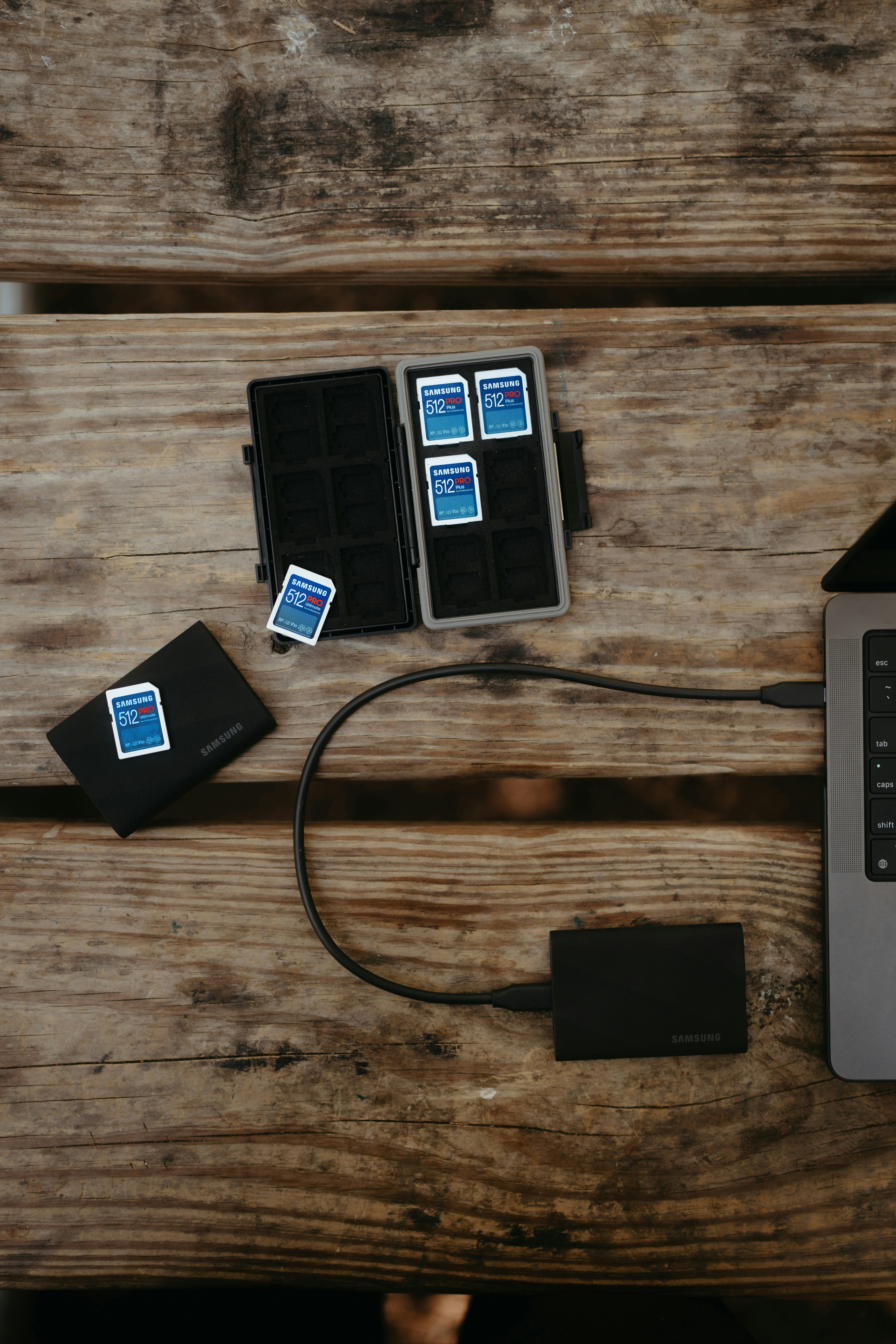 Memory cards and external hard drives connected to a laptop.