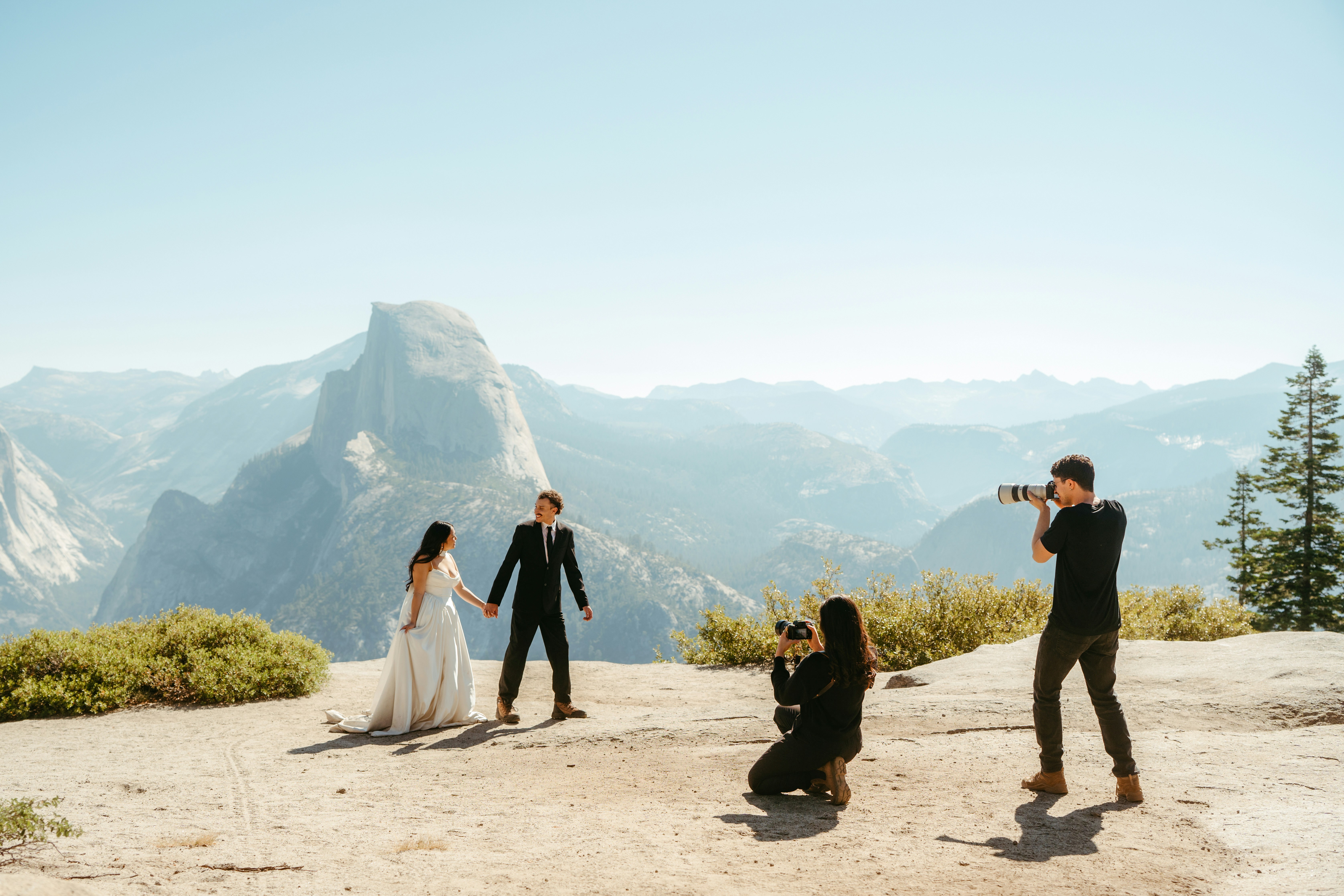 Photographer capturing couple with mountain backdrop
