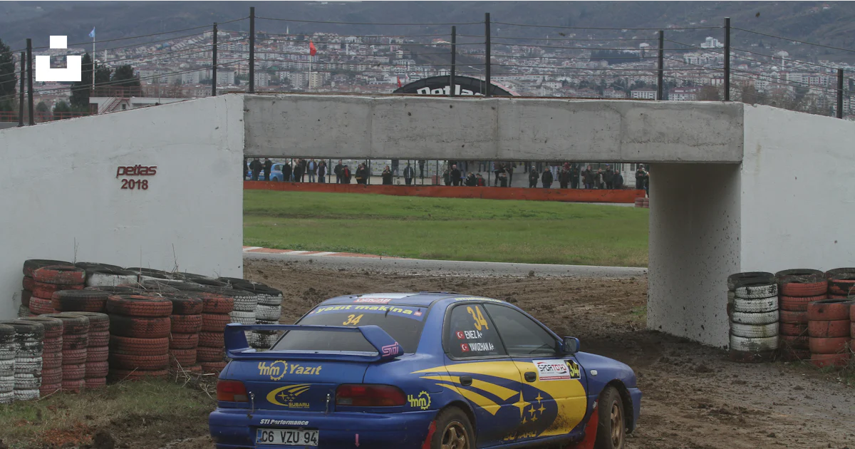 Blue rally car driving on a dirt track photo – Free Car Image on Unsplash