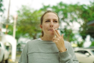 Young woman smoking a cigarette outdoors