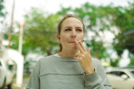 Young woman smoking a cigarette outdoors