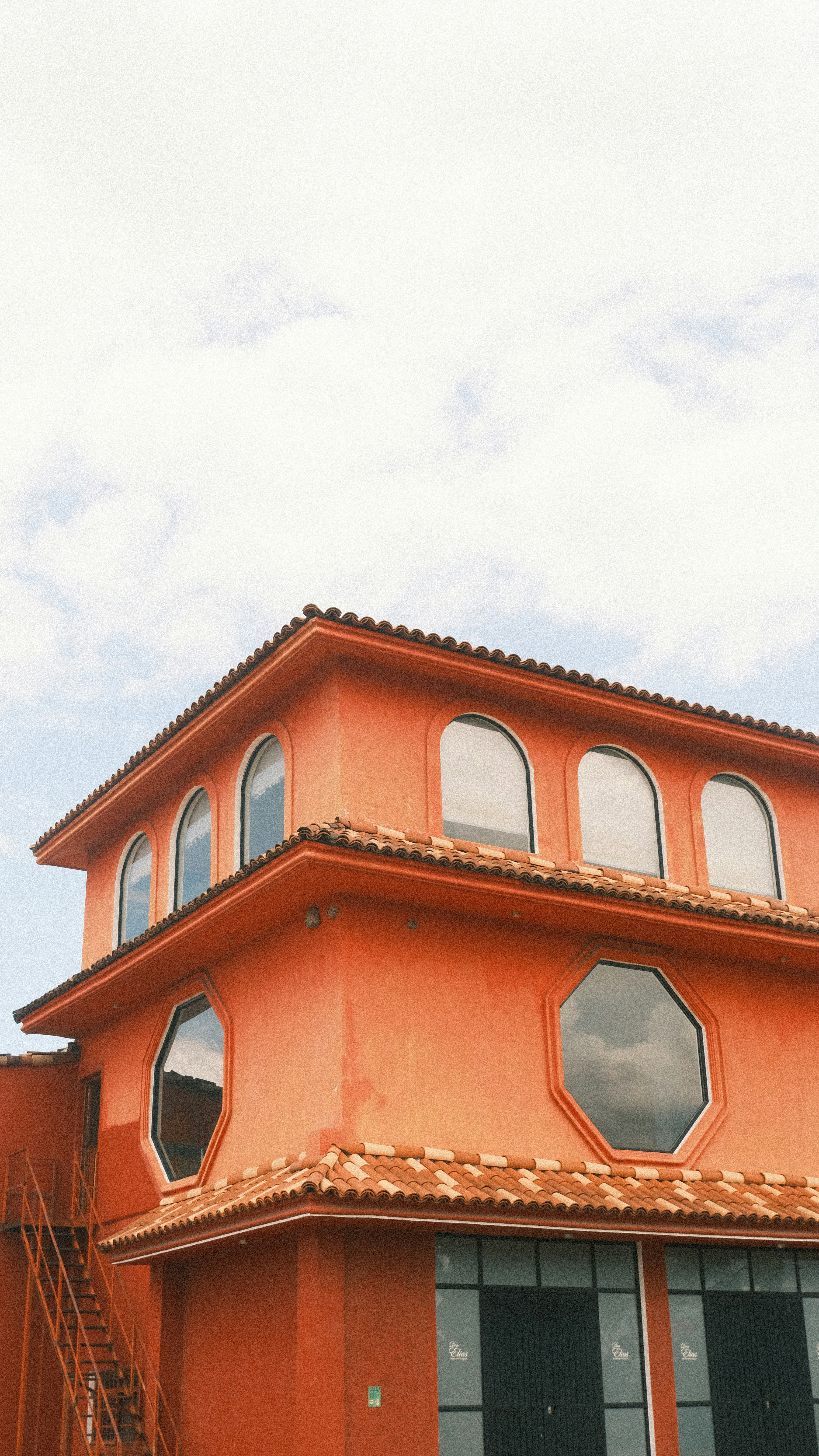 Orange building with arched and octagonal windows