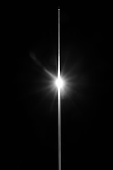 Bright starburst flares with a thin vertical line.
