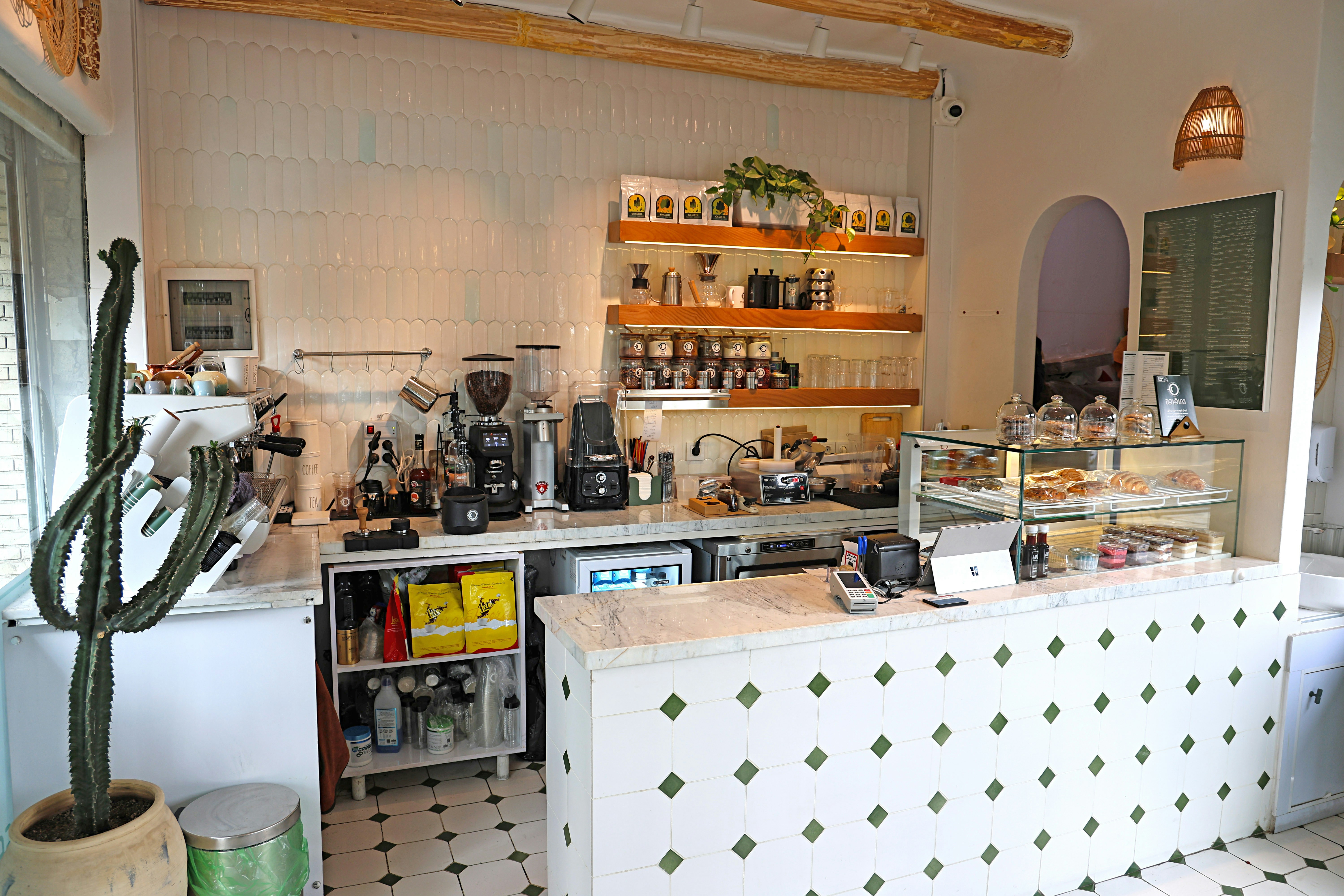 Stop image for Lowcountry to Blue Ridge: 3-Day Spring Road Trip - Modern cafe counter with pastries and coffee equipment. -  in Southeast USA - Photo by Babak Eshaghian on Unsplash