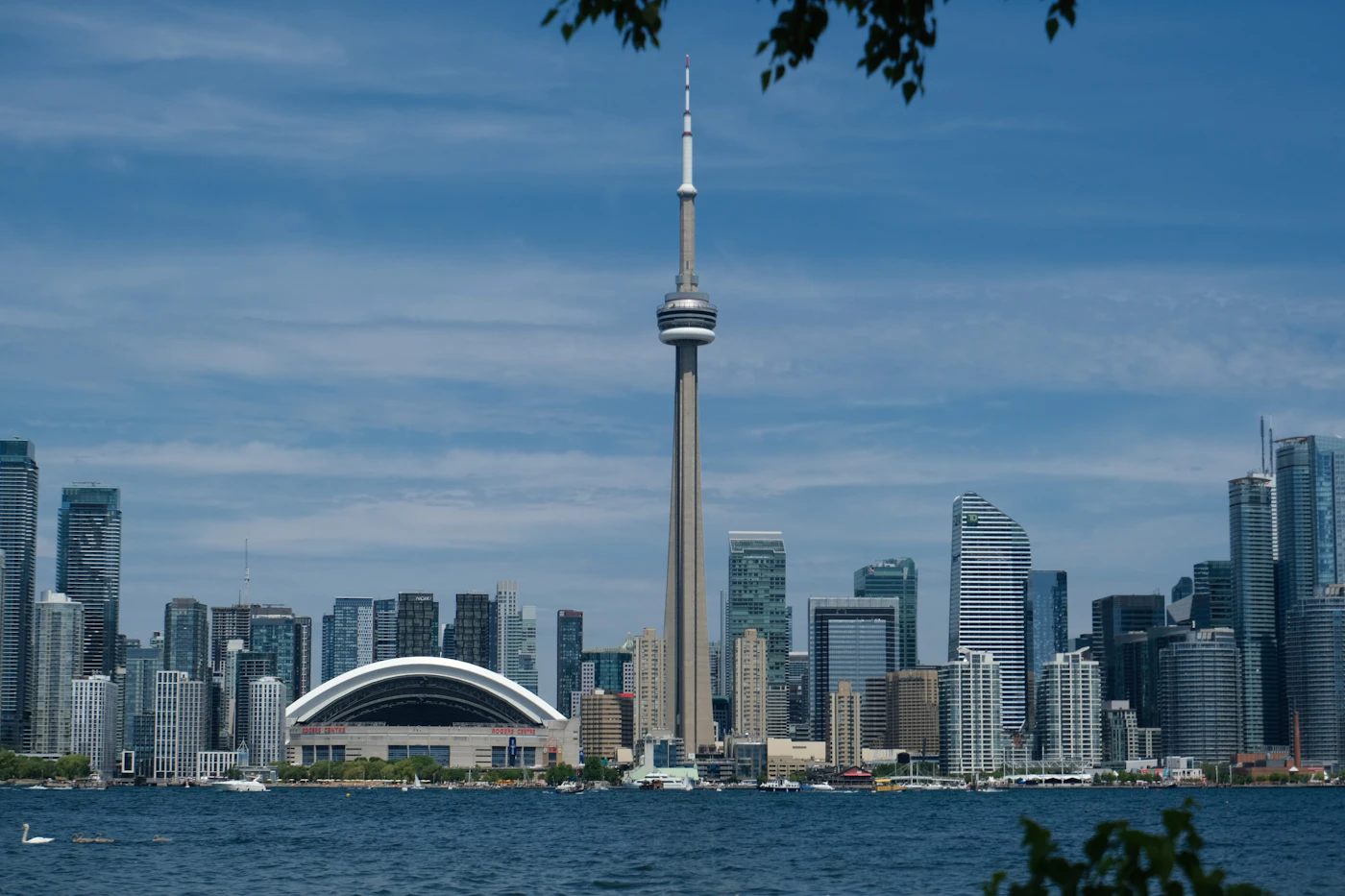 The Toronto skyline with the CN Tower and Rogers Centre rising above the city at dusk