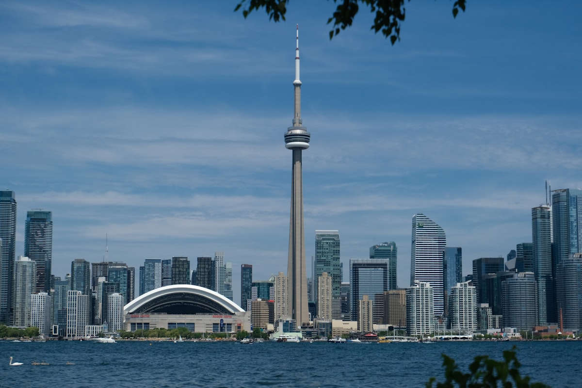 Toronto skyline viewed across Lake Ontario, with the CN Tower and Rogers Centre dome visible from Toronto Islands