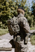 Soldier with backpack in wooded area