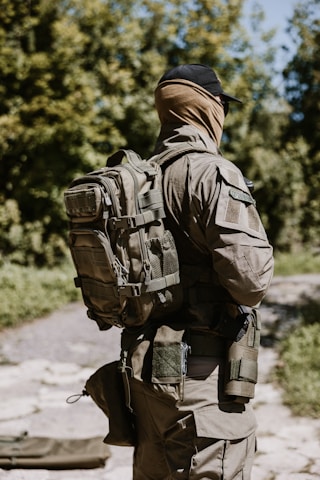 Soldier with backpack in wooded area