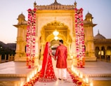 Couple in traditional indian wedding attire holding hands