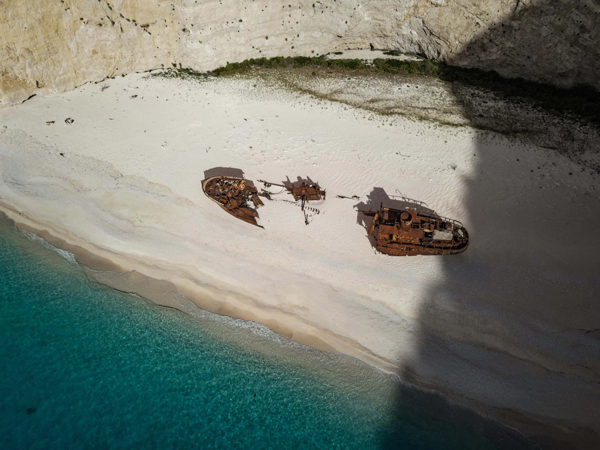 Aerial view of shipwrecks on a sandy beach with turquoise water on Zante