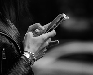 Woman's hands typing on a smartphone