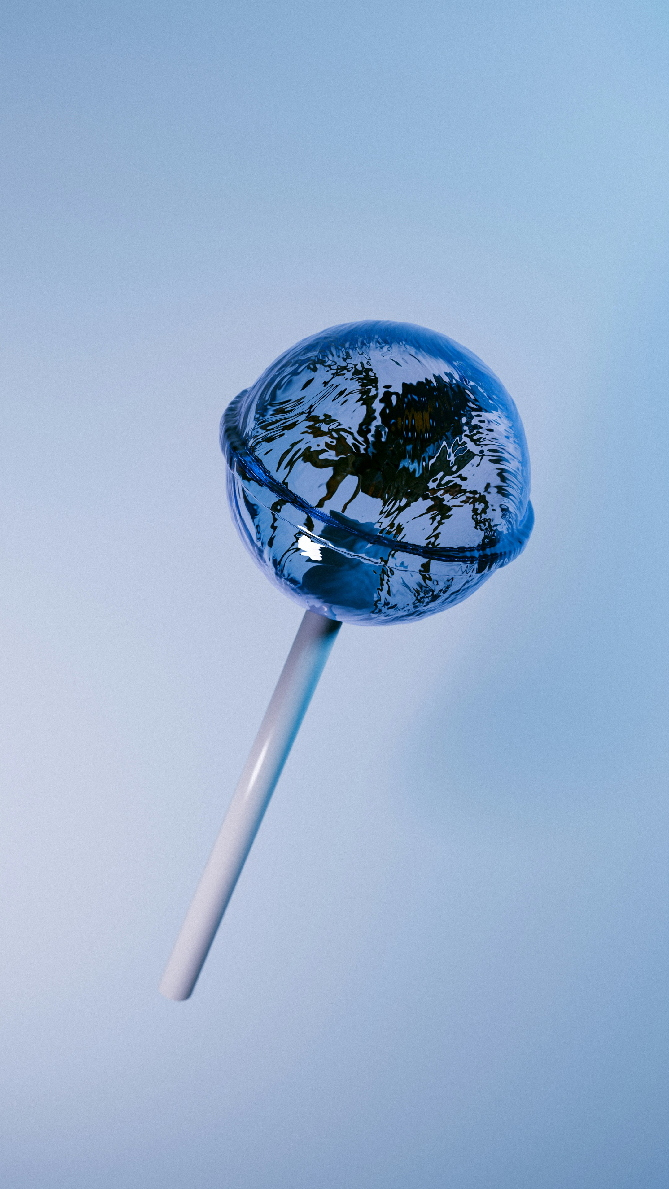Lollipop with reflection of earth on blue background