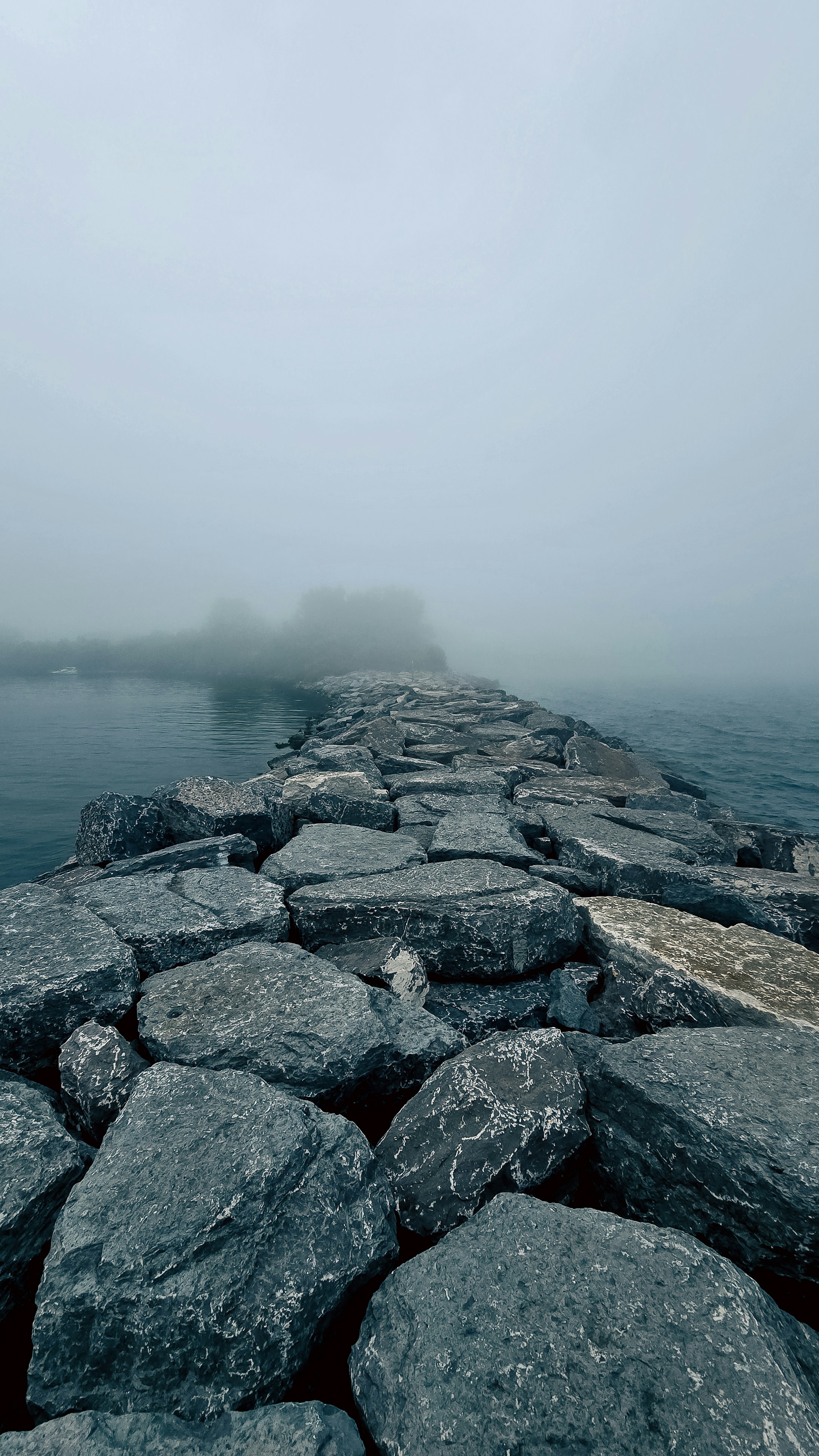 Stone path leading into foggy water