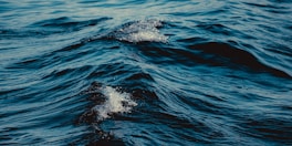 Rippling blue ocean waves with white foam