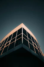 Modern building corner with dark glass windows