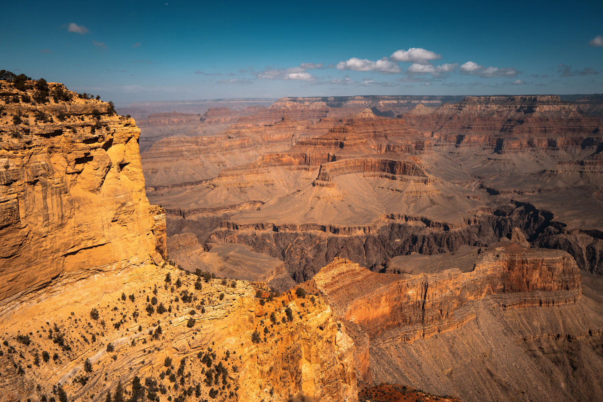 Vast canyon landscape with layered rock formations under sky