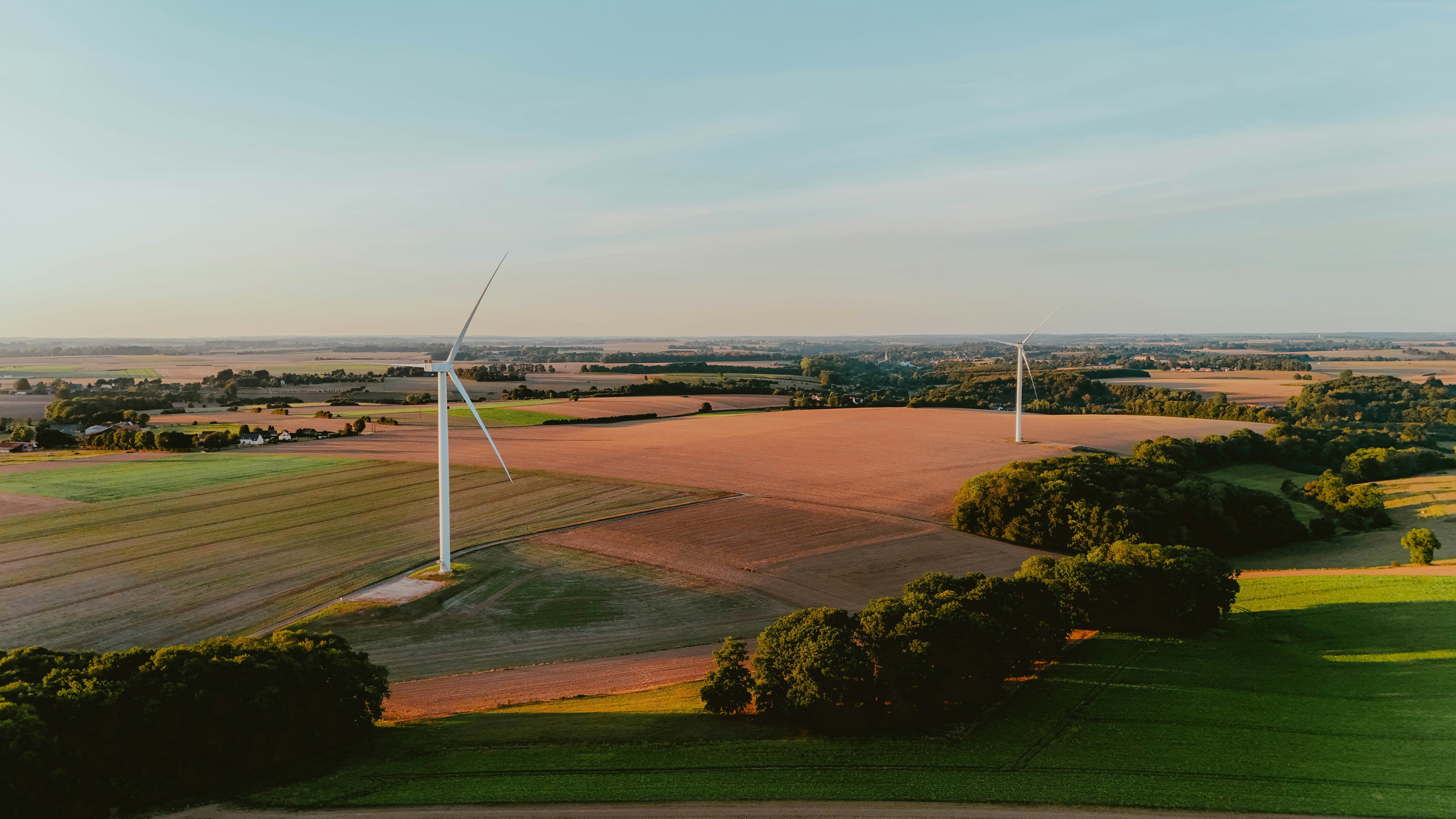 Wind turbines in a rural landscape at sunset