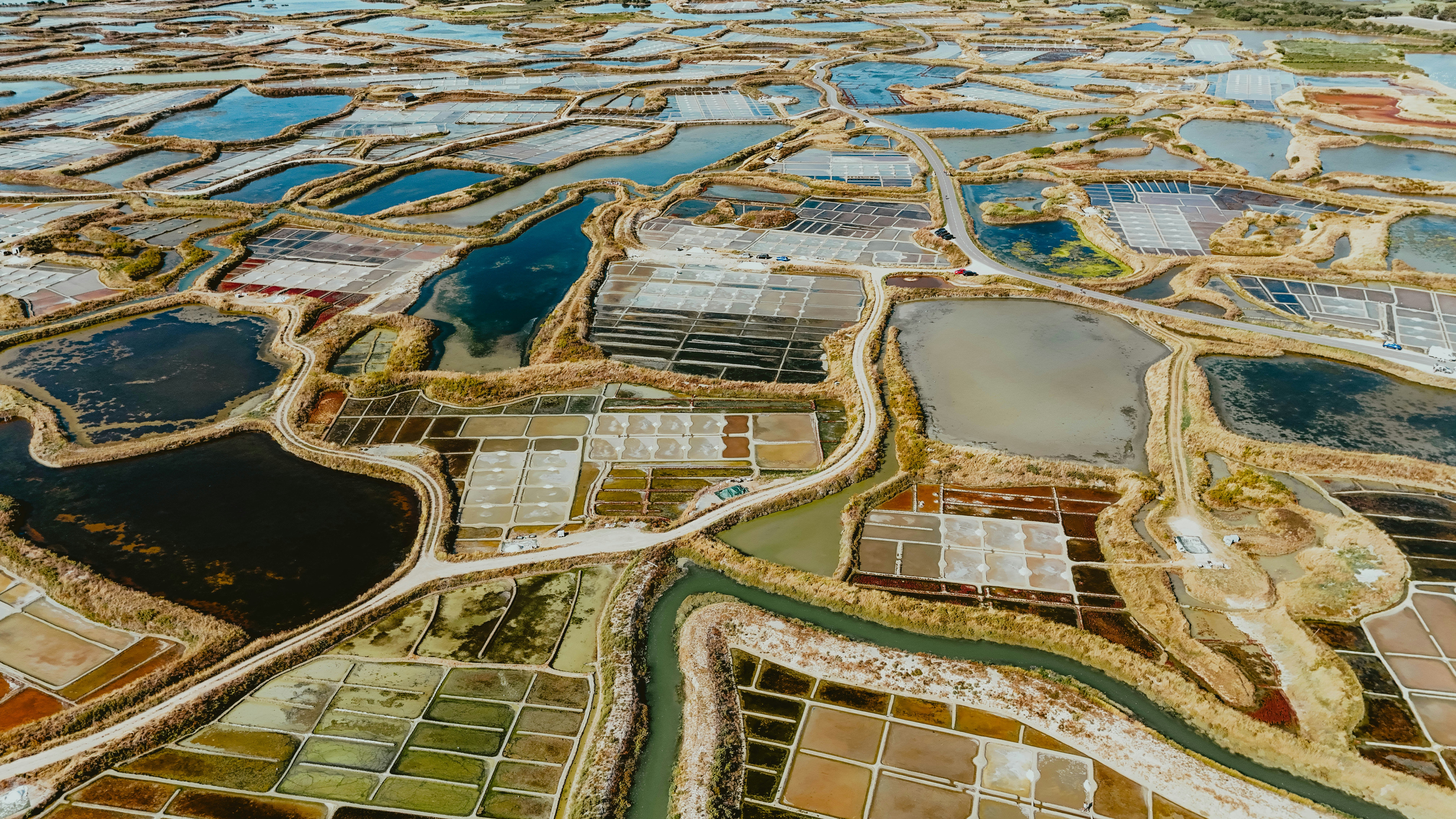 Aerial view of colorful salt evaporation ponds.