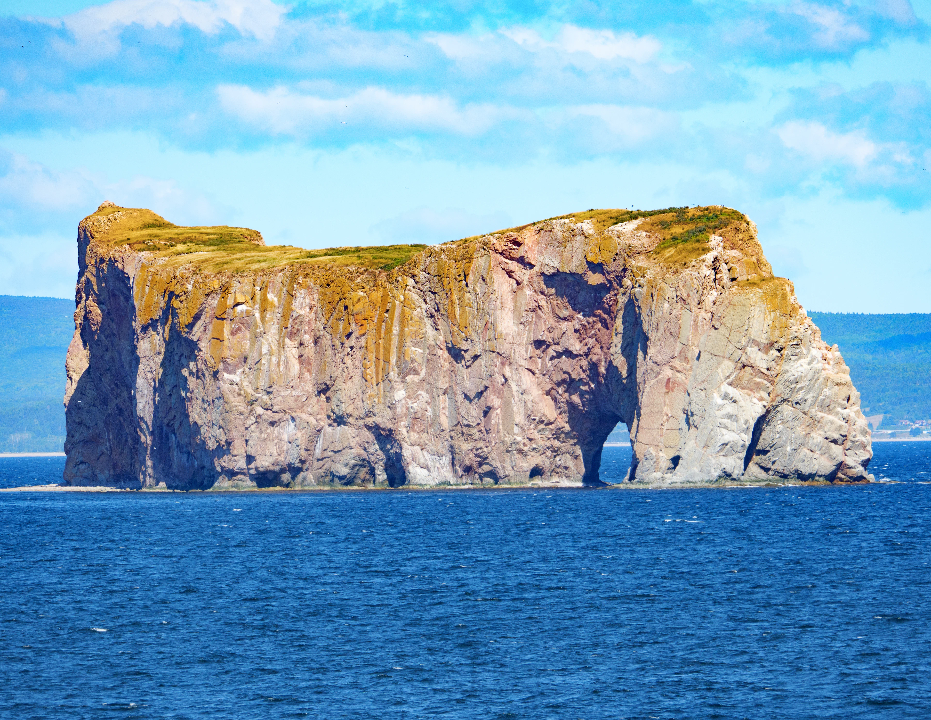 Percé Rock and its arch rising from the sea in the Gaspé