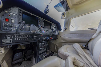 Airplane cockpit with seats and control panel.